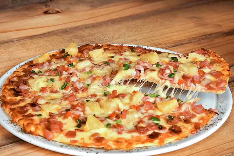 Hawaiian Pizza – the perfect blend of pineapple, tasty ham, and cheesy goodness.